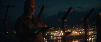 a man standing in front of a city at night