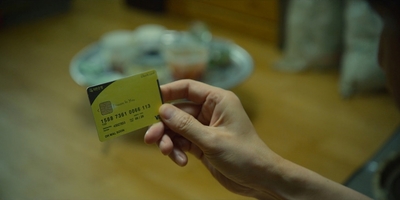 a person holding a credit card in their hand