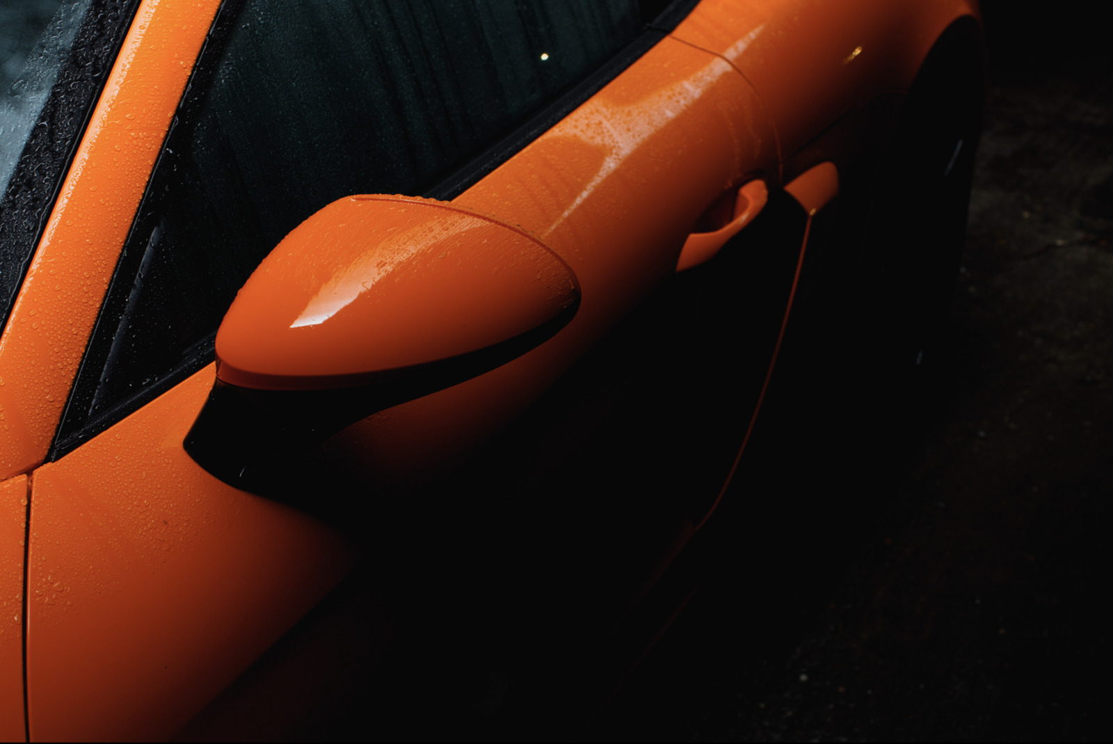 a close up of an orange car door handle