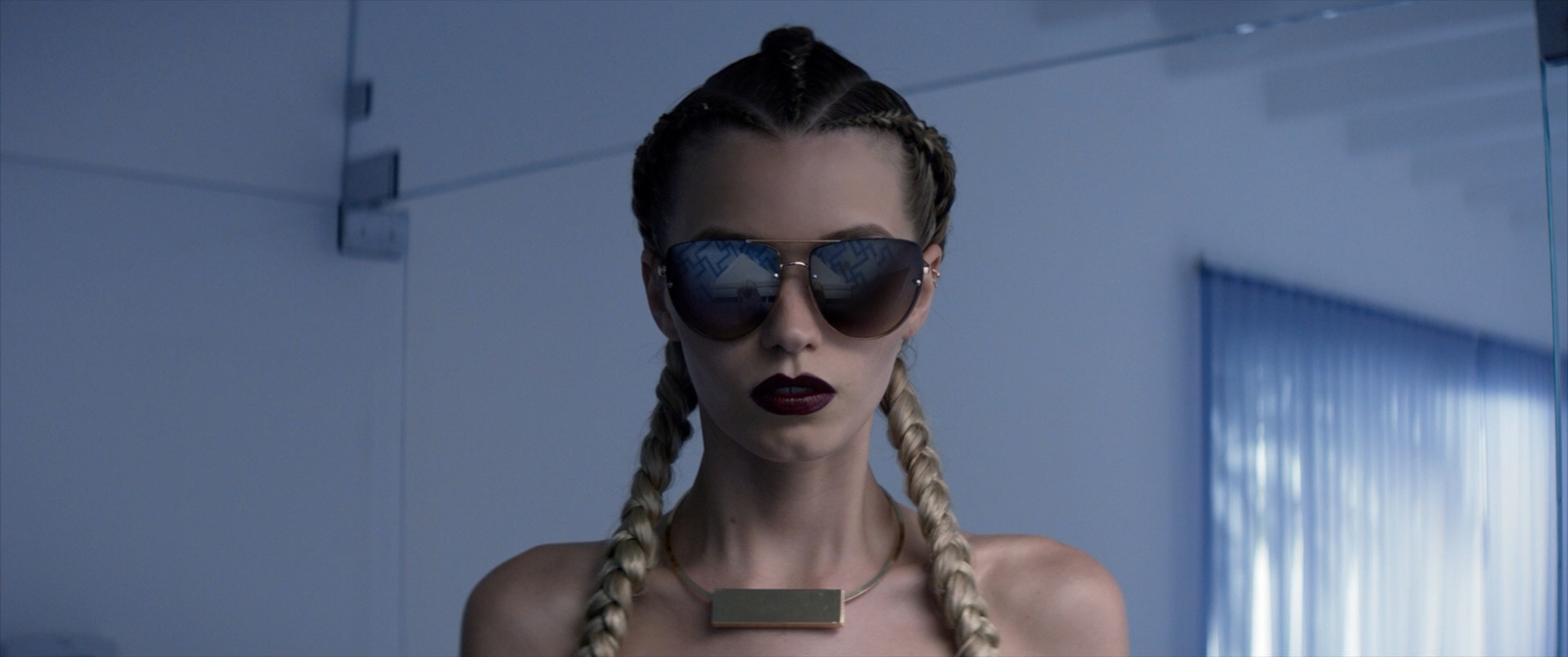 a woman with long braids wearing sunglasses