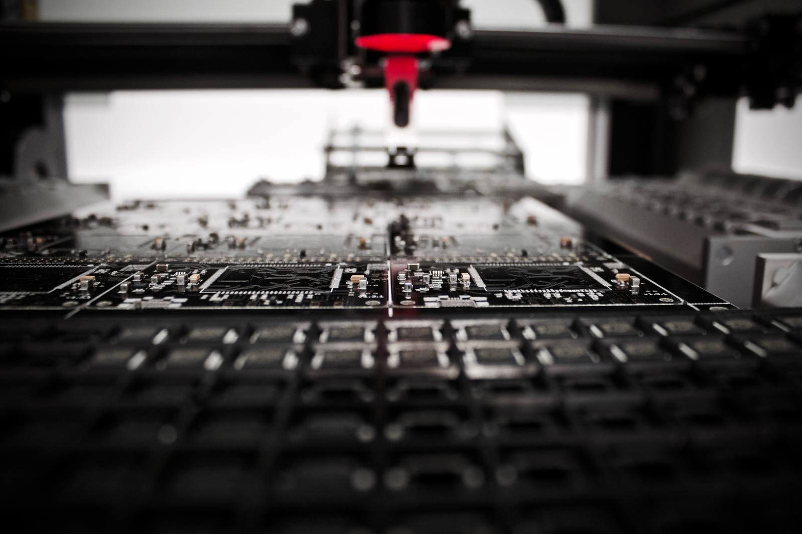 a close up of a machine with a red object in the background