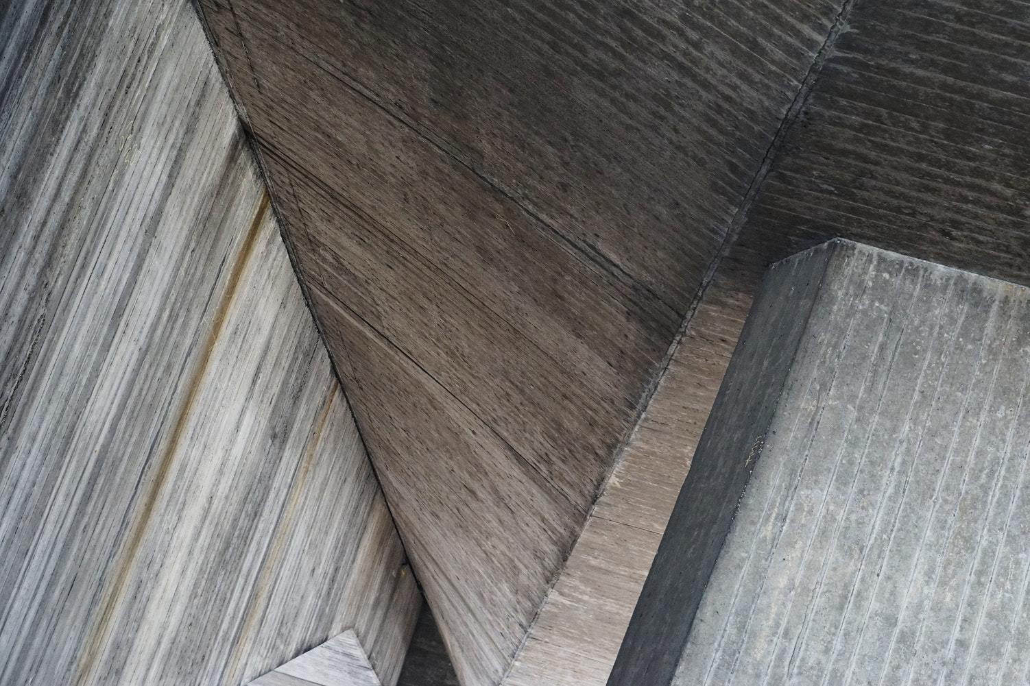 a clock on the side of a wooden building