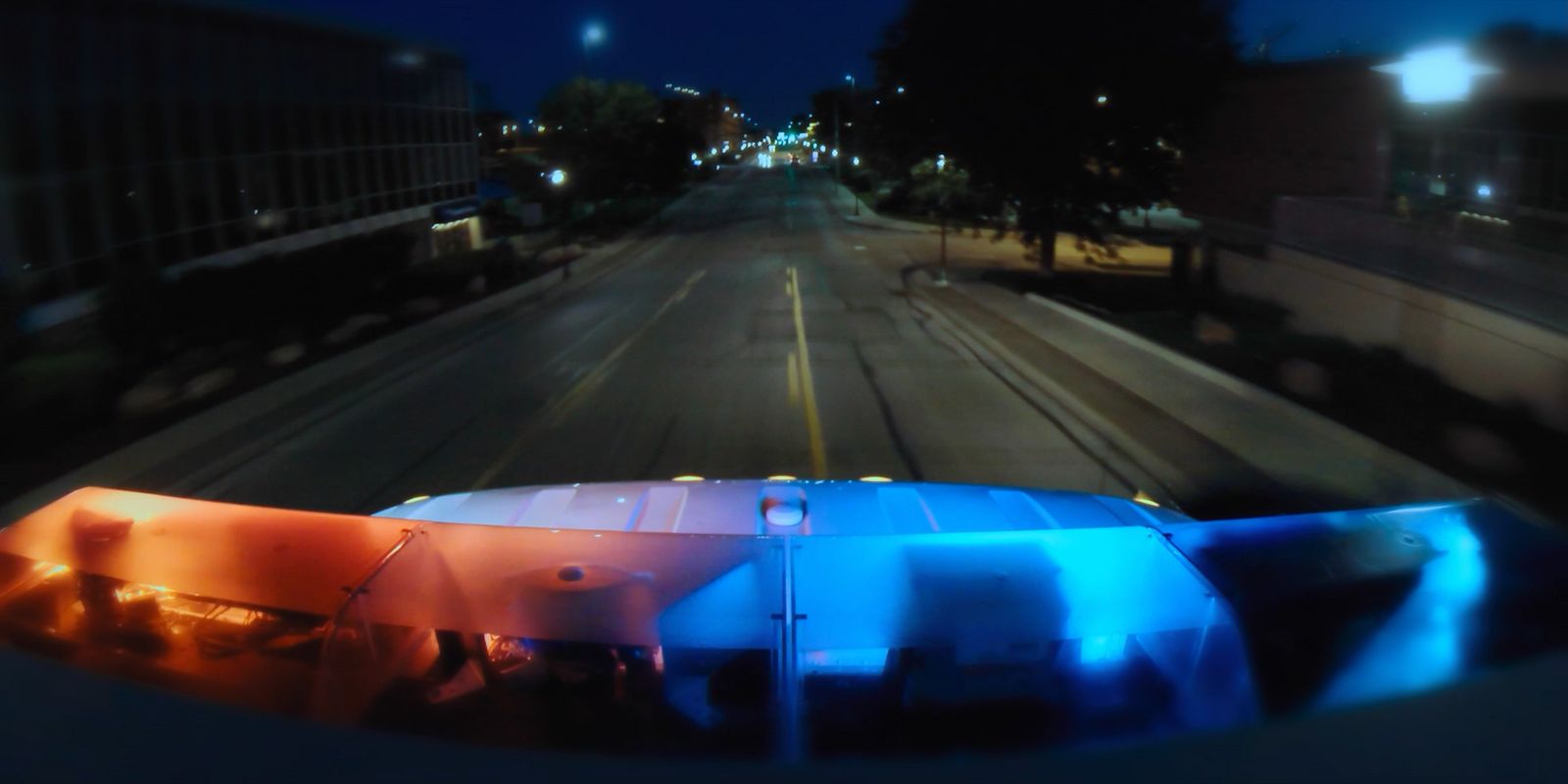 a view of a city street at night from a vehicle