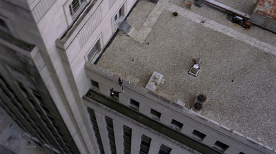 an aerial view of a building with people walking around