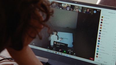 a person sitting in front of a computer monitor