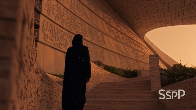 a man in a black robe is walking up some stairs