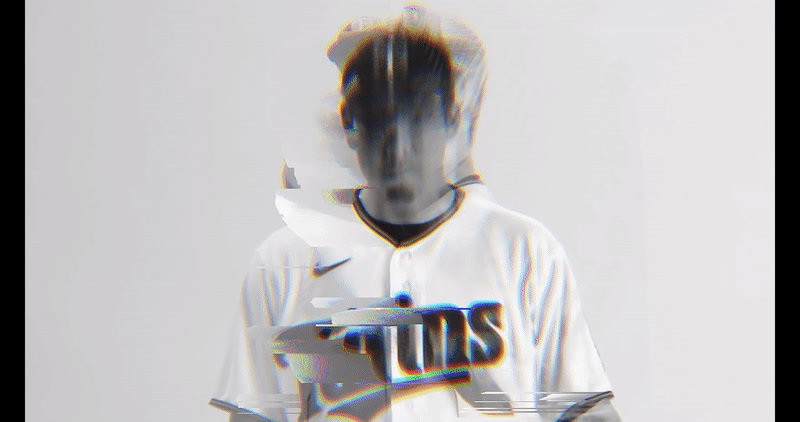 a blurry image of a baseball player holding a bat