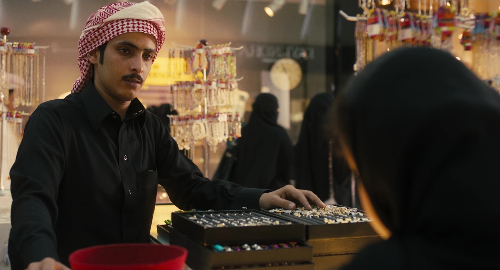 a man wearing a turban standing next to a woman