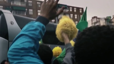 a person holding a stuffed animal in the back of a truck