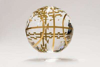 a glass ball with gold lines on it