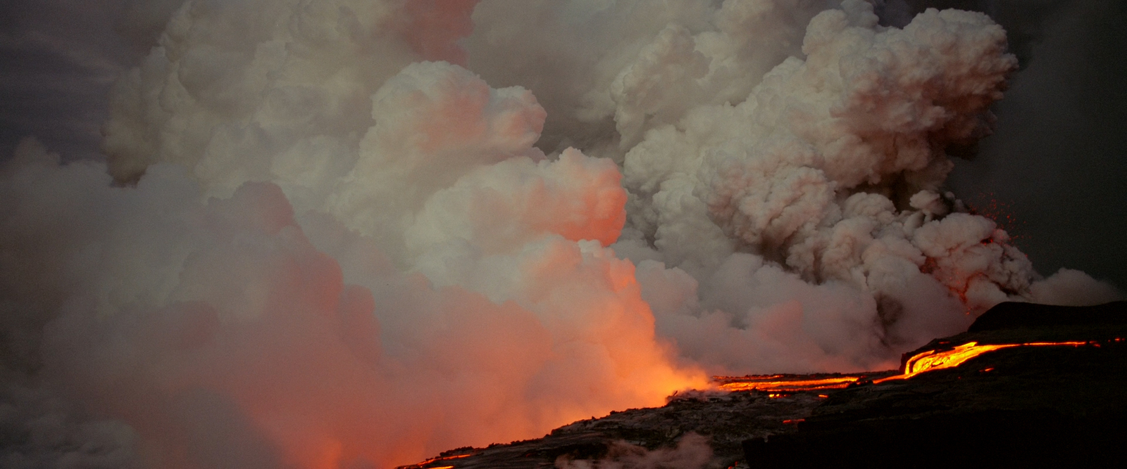 a large plume of smoke coming out of a volcano