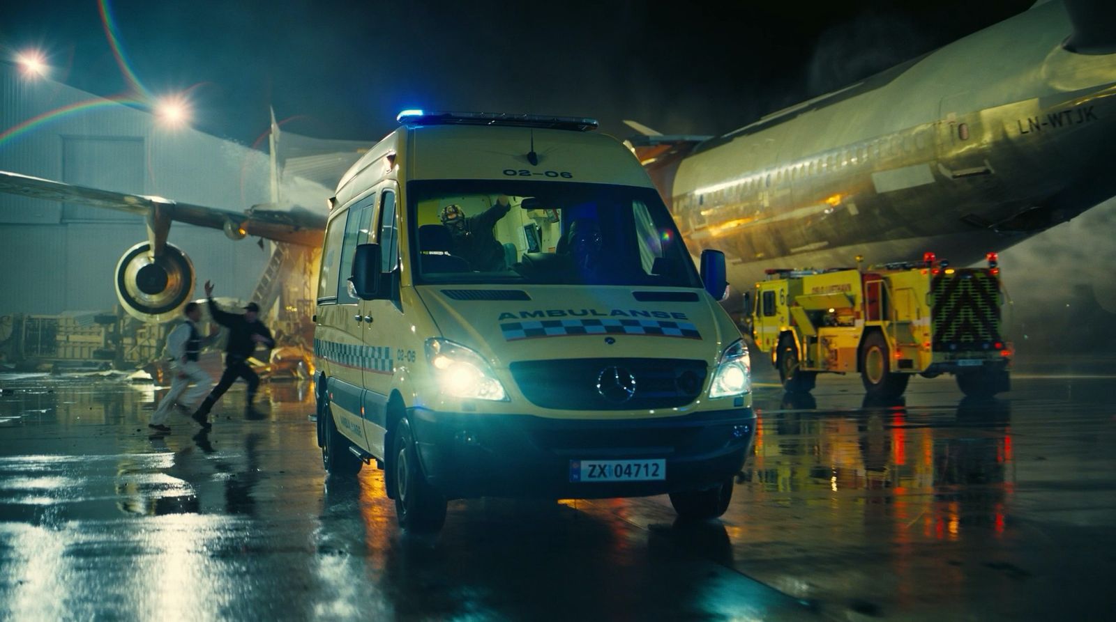 an ambulance is parked next to an airplane