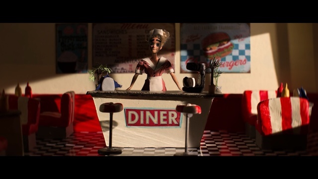 a woman standing behind a counter in a diner