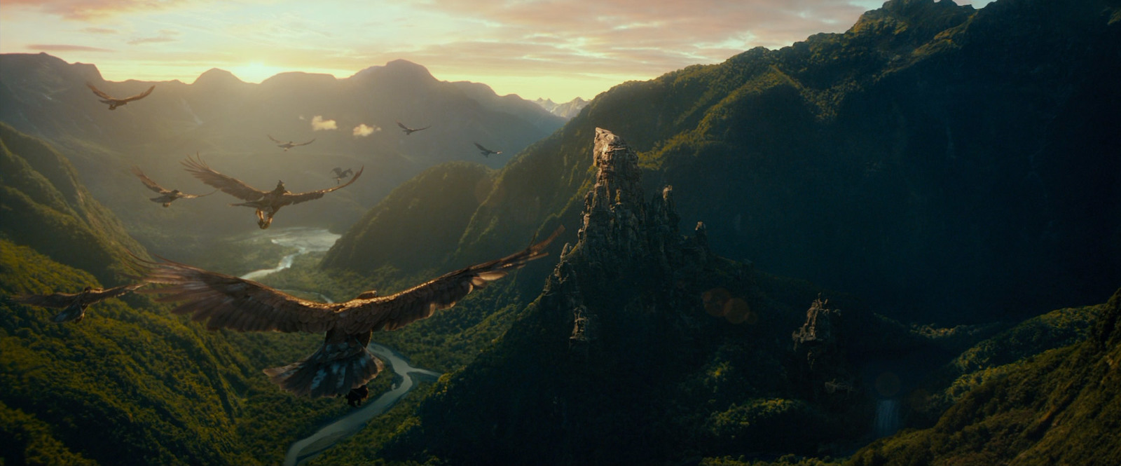 a large bird flying over a lush green valley