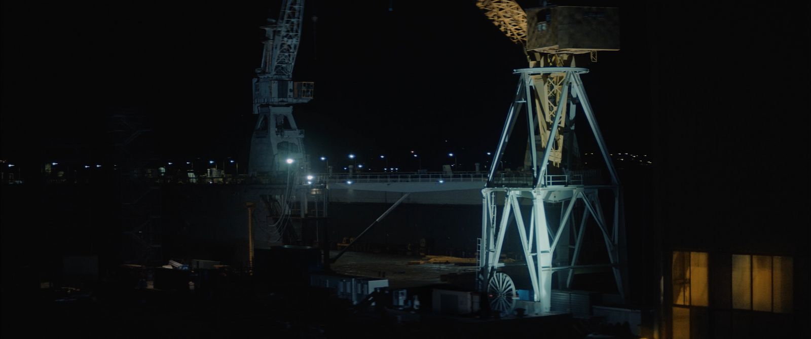 a tower crane is lit up at night