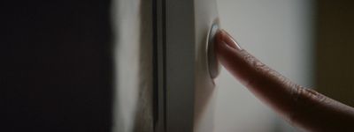 a hand pushing a button on a door