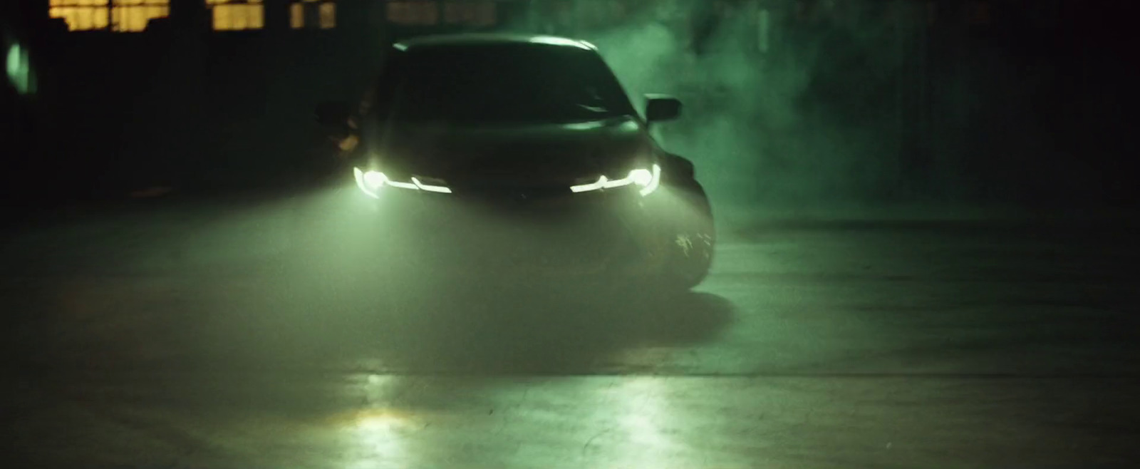 a car driving down a street at night