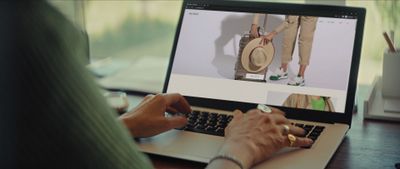 a person using a laptop computer on a desk