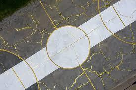 an aerial view of a street with a yellow line painted on it