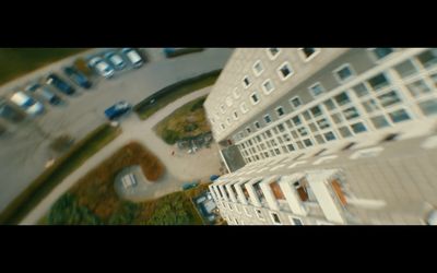 an aerial view of a building and a parking lot