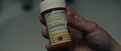 a person holding a bottle of pills in their hand