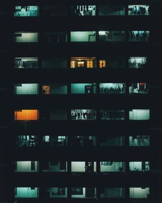 a very tall building with lots of windows at night