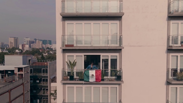 a person standing on the balcony of a tall building