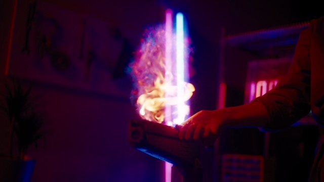 a person holding a pipe in a dark room