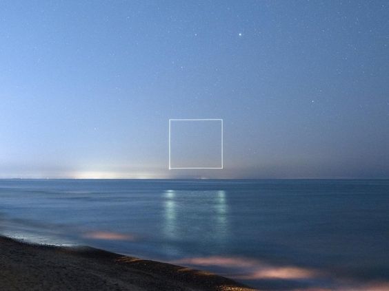 a view of the ocean from a beach at night