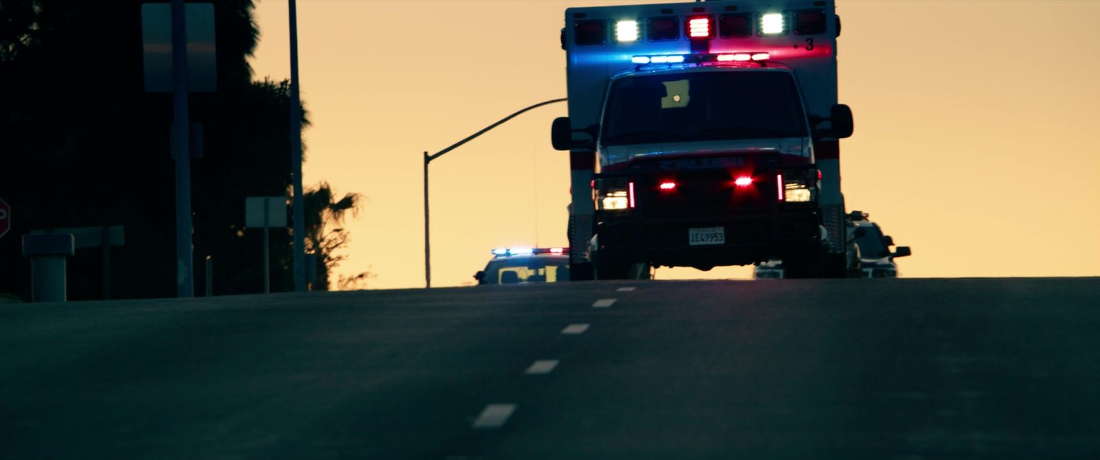 a police truck with its lights on driving down the road