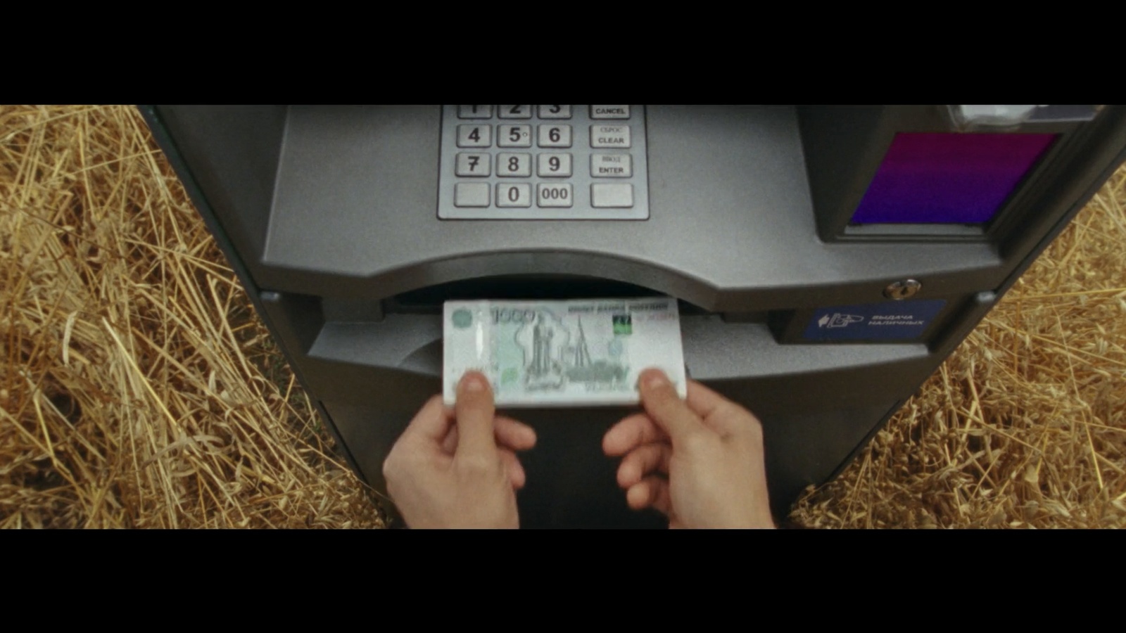 a person putting money into an atm machine