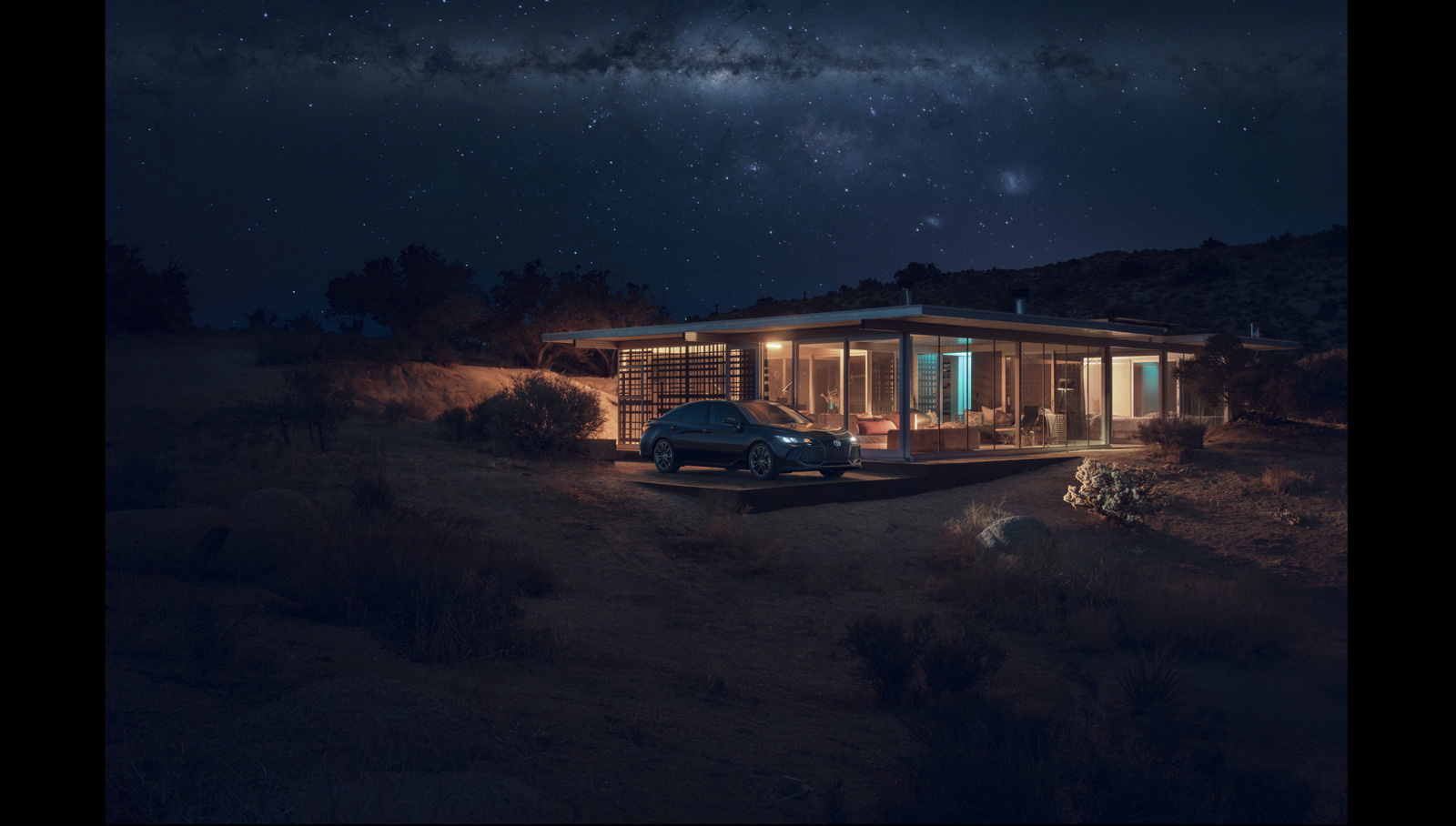 a truck parked in front of a house at night