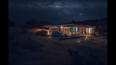 a truck parked in front of a house at night