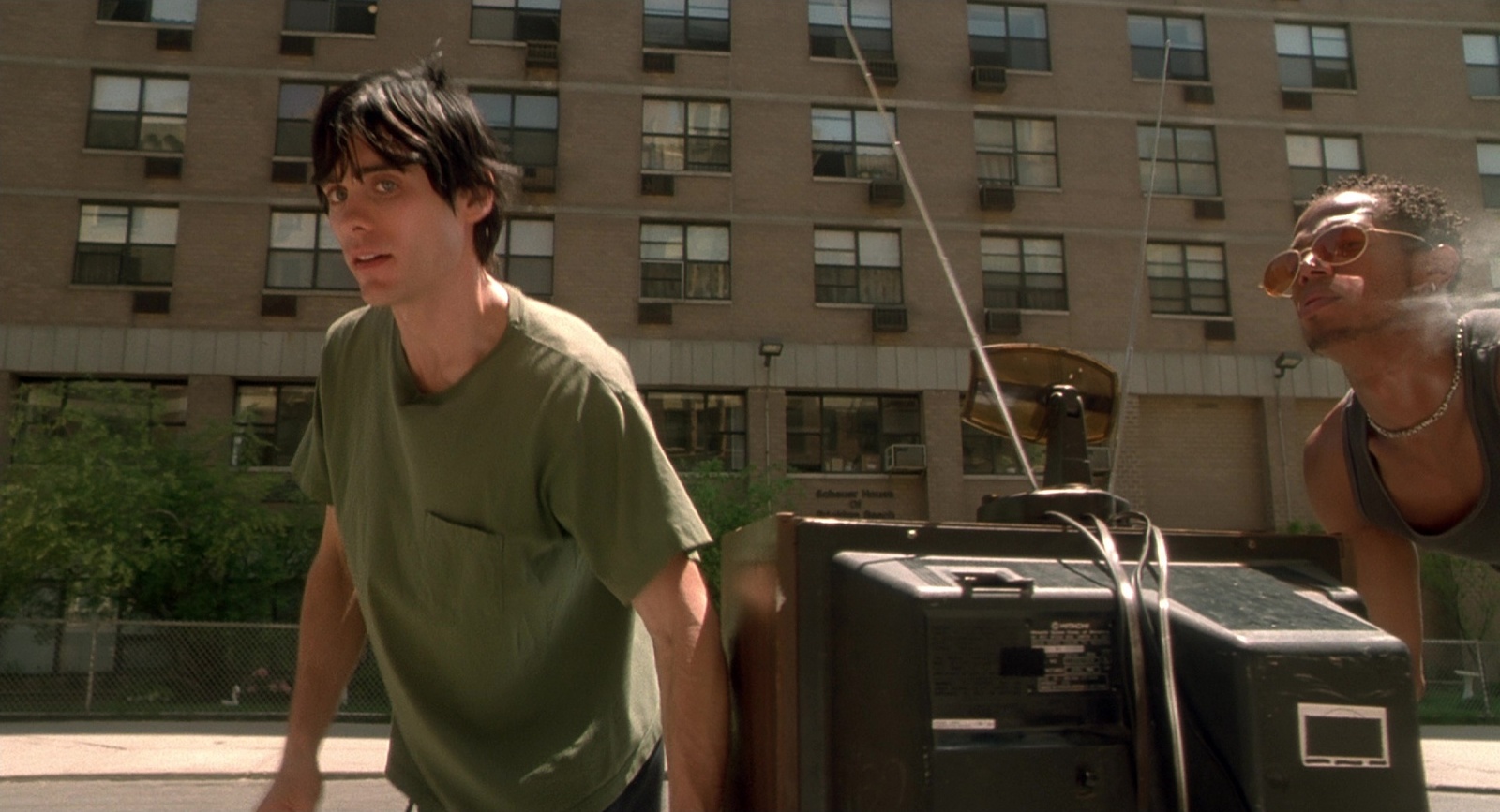 two young men are standing in front of a radio