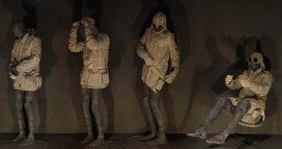 a group of statues of people standing next to each other