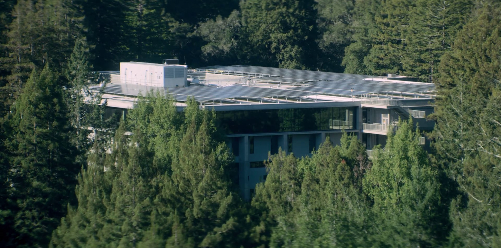 an aerial view of a house surrounded by trees