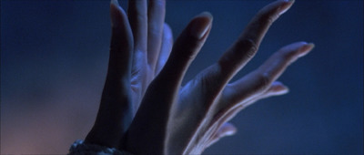 a close up of a person's hands in the dark