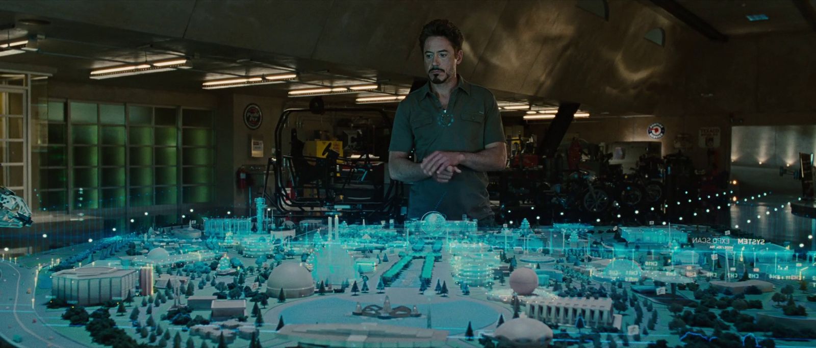 a man standing in front of a model of a city