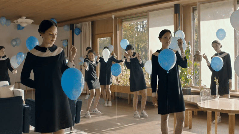 a group of women standing in front of a mirror