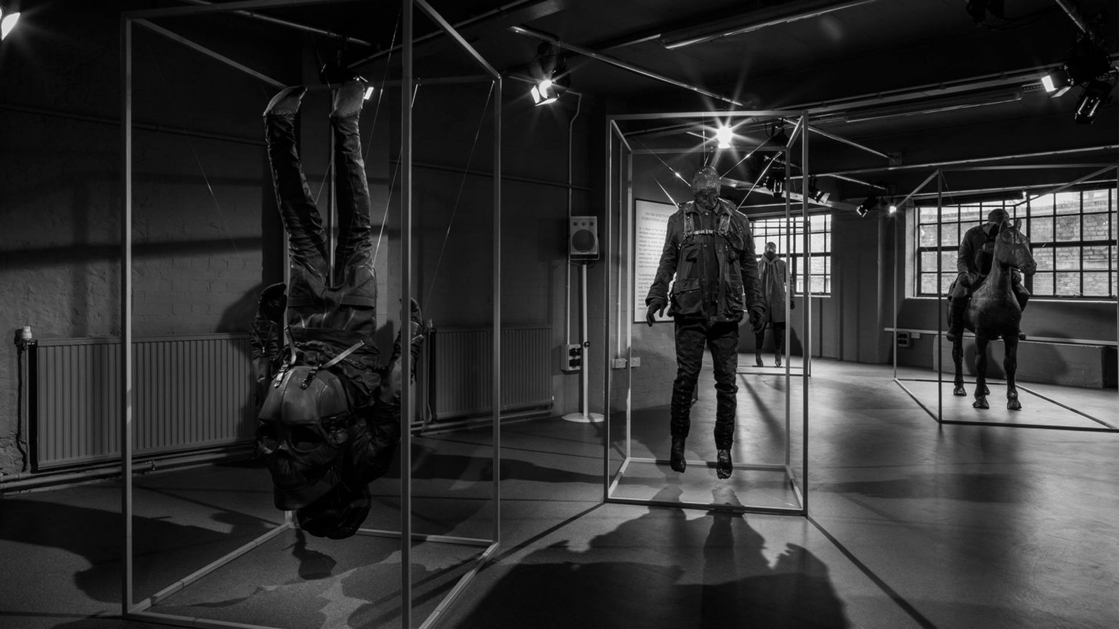 a black and white photo of two mannequins in a room