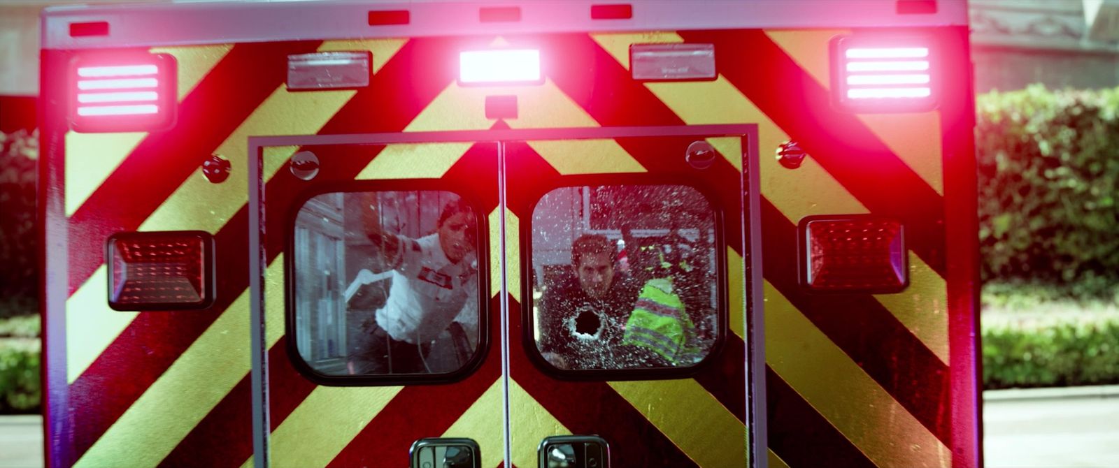 a red and yellow fire truck with its lights on