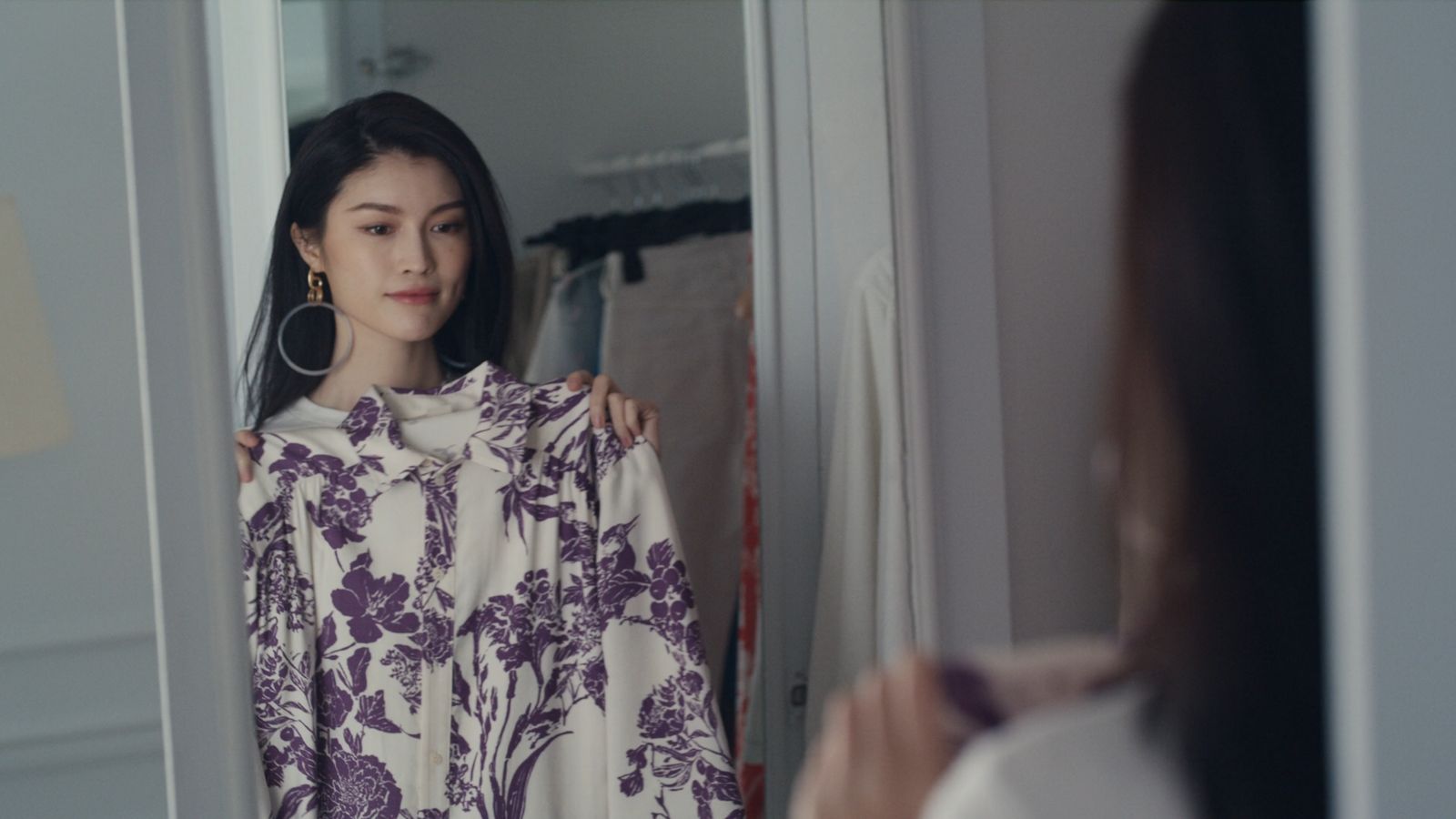 a woman standing in front of a mirror