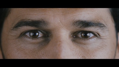 a close up of a man's face with brown eyes