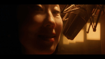 a close up of a person in front of a microphone