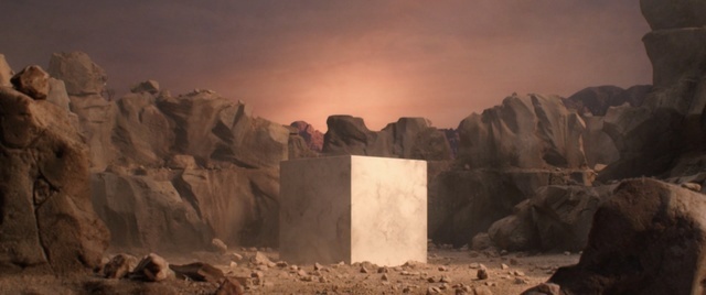 a small white box sitting in the middle of a desert