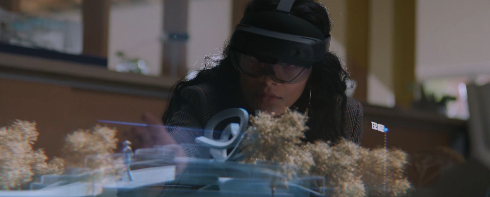 a woman wearing a headset looking at a computer screen