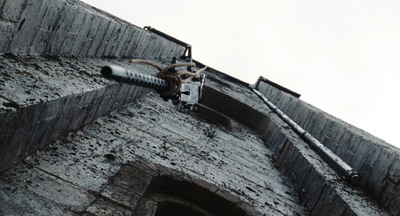 a metal pipe sticking out of the side of a brick building