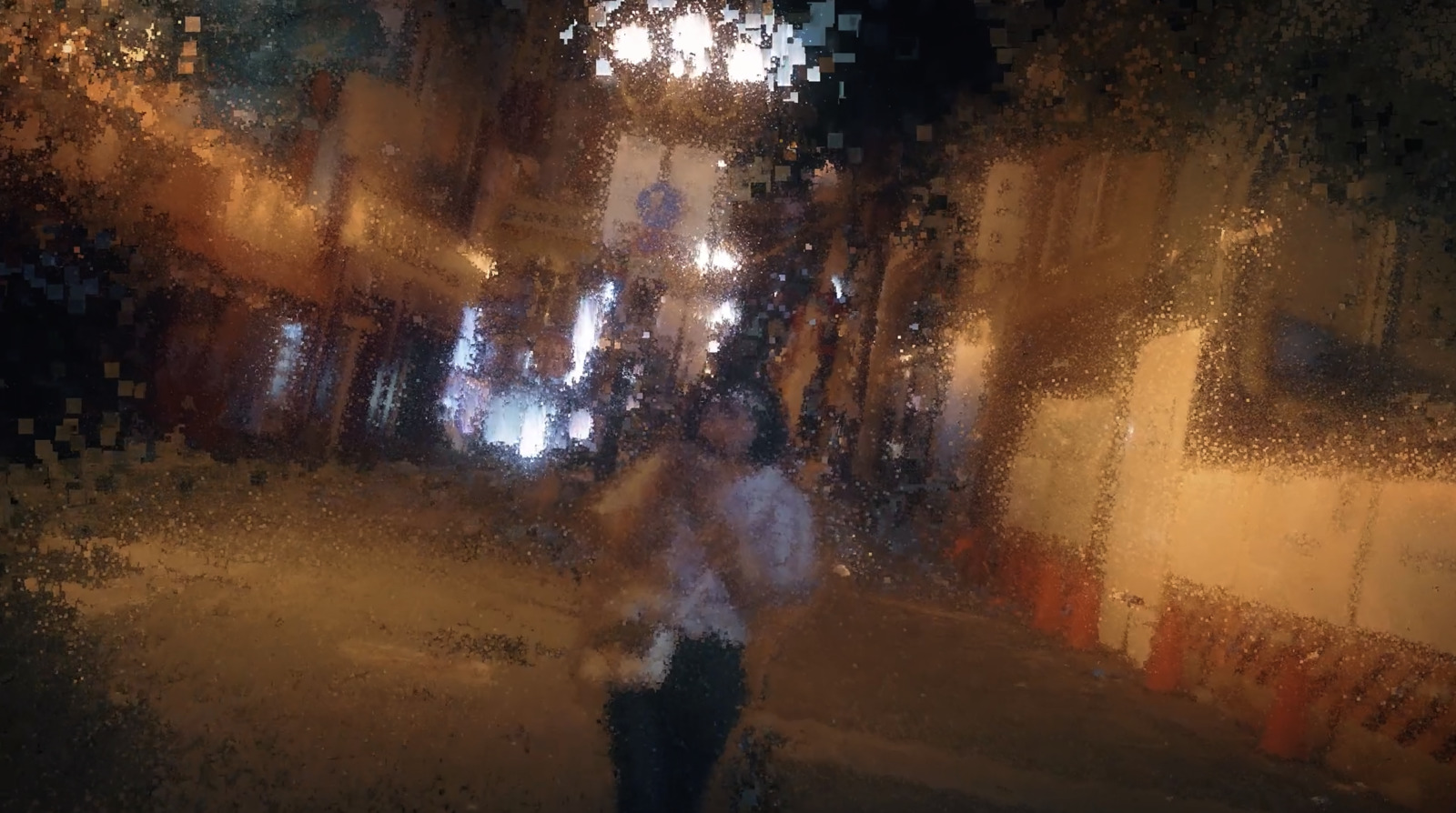 a blurry image of a person walking down a street