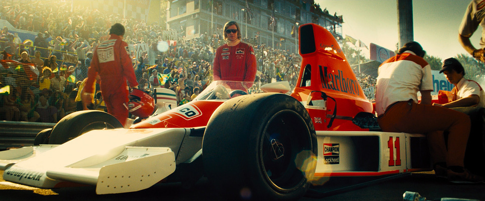 a man in a race car in front of a crowd