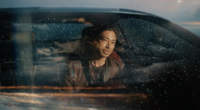 a man sitting in the passenger seat of a car